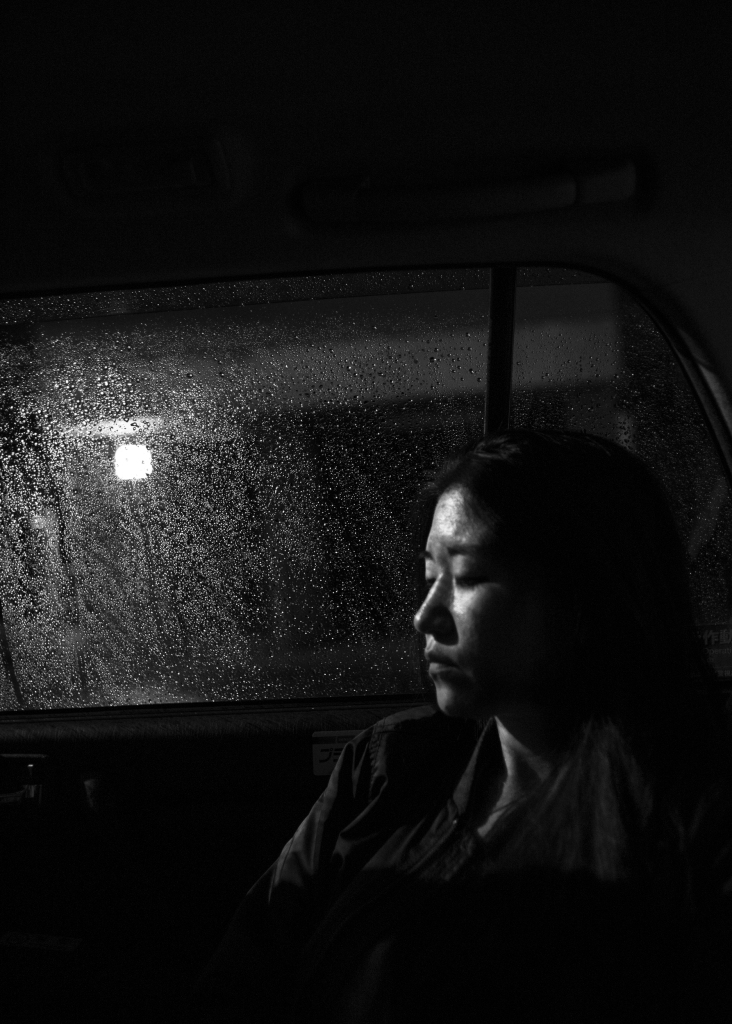 woman in the car with rain outside